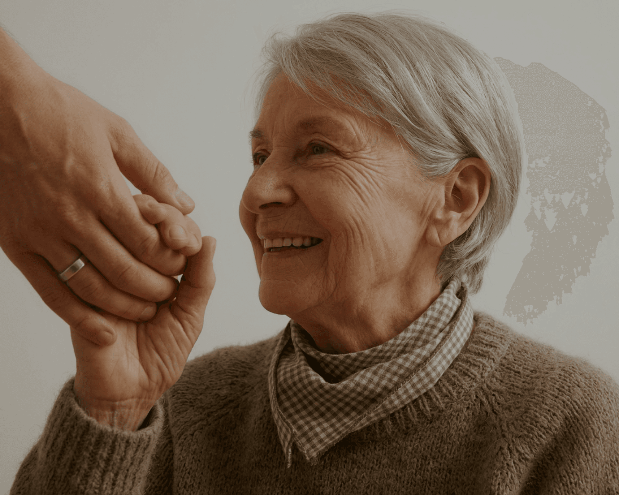 Caregiver and senior holding hands